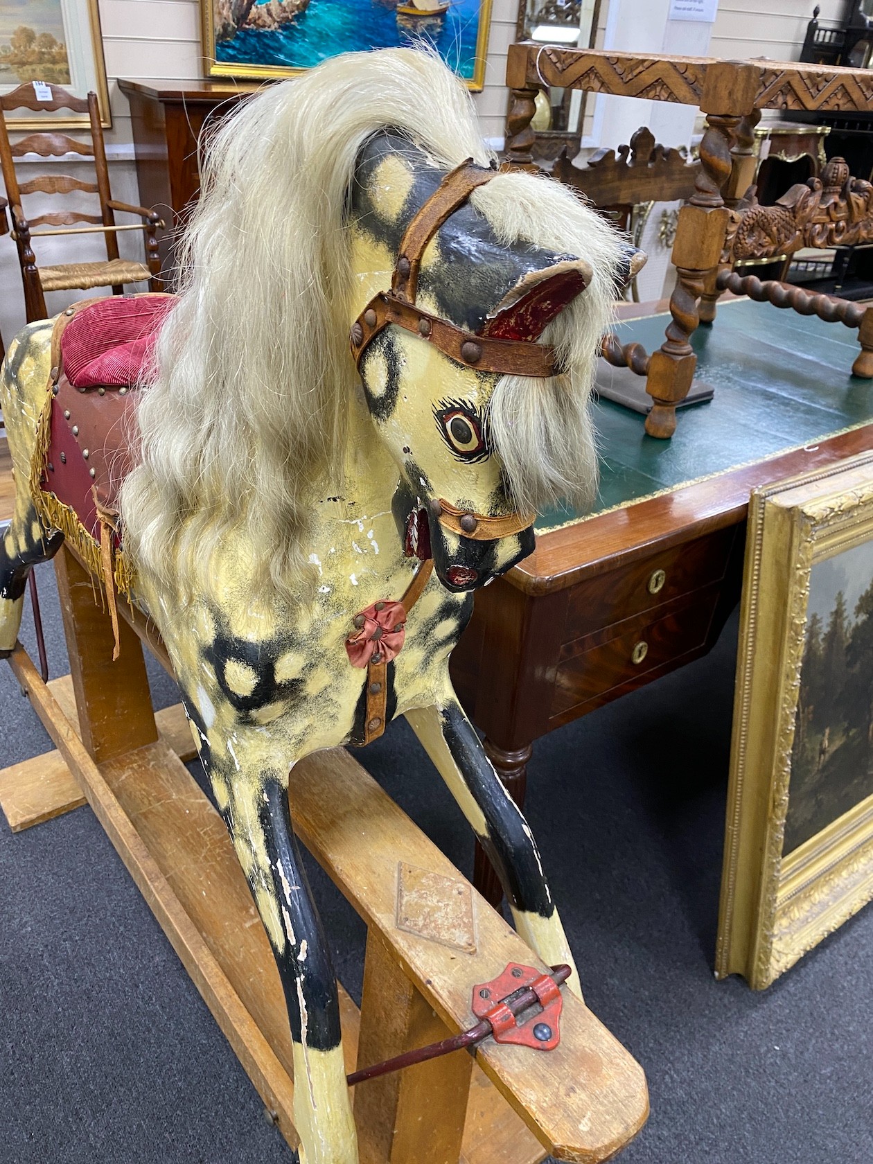 A mid 20th century Ayres type dapple rocking horse on pine safety frame height 122 cms